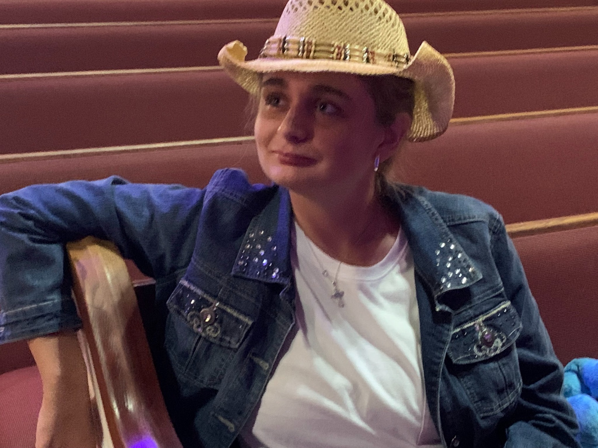 Sydney wearing a hat and denim jacket
