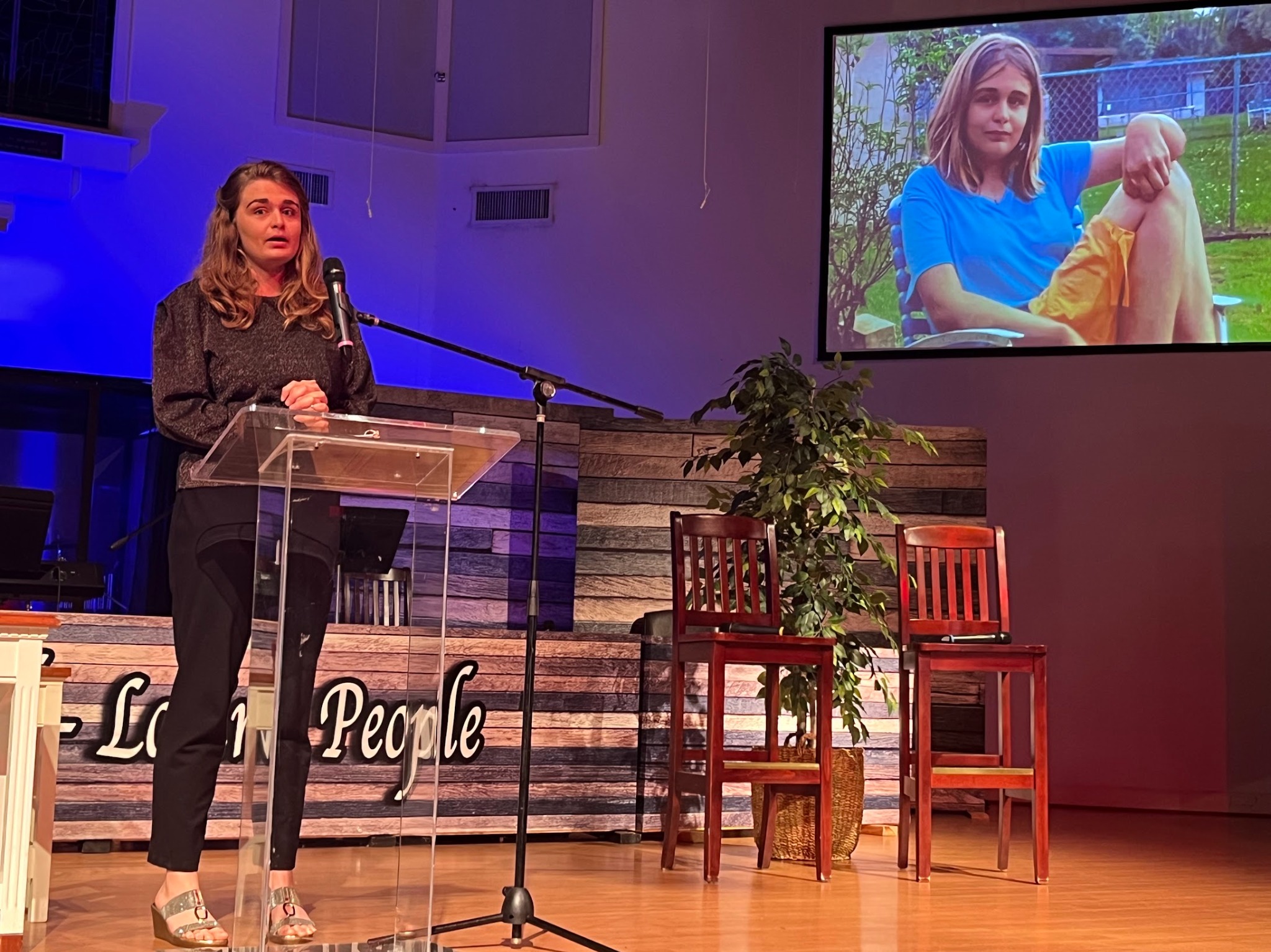 Sydney speaking on stage