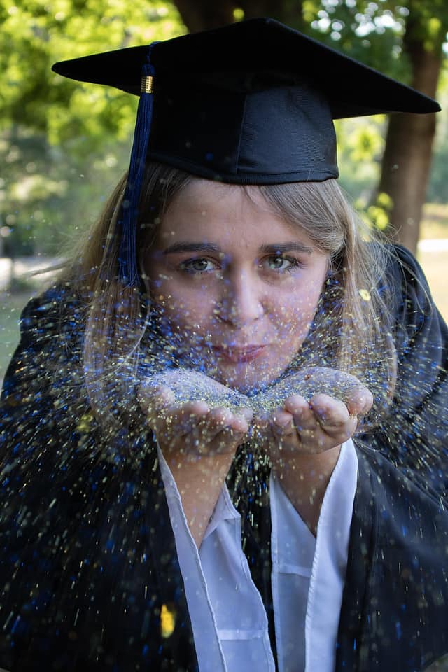 Sydney in graduation attire with glitter